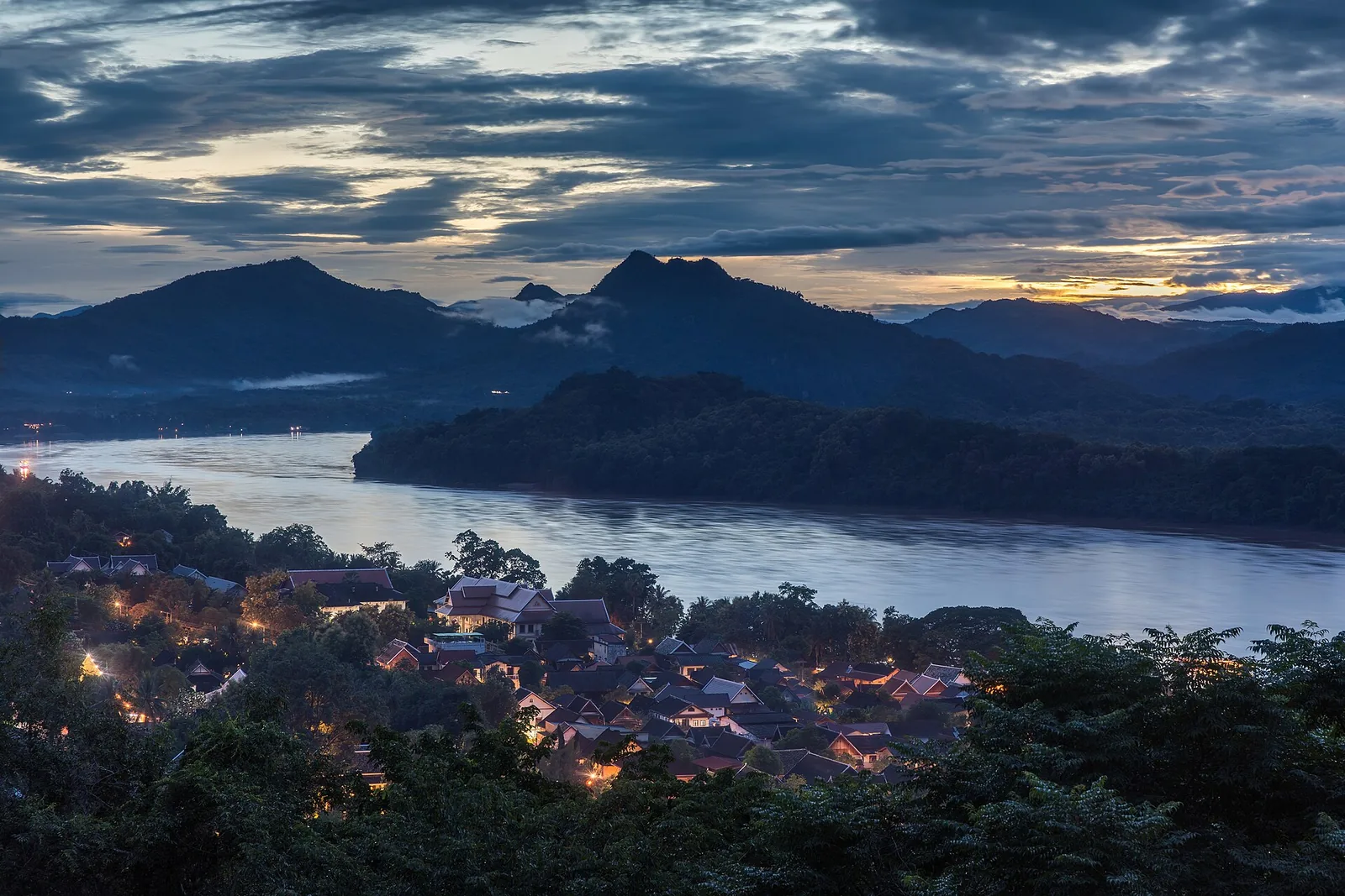 Dusk view over Luang Prabang, the Mekong and misty mountains from Mount Phousi