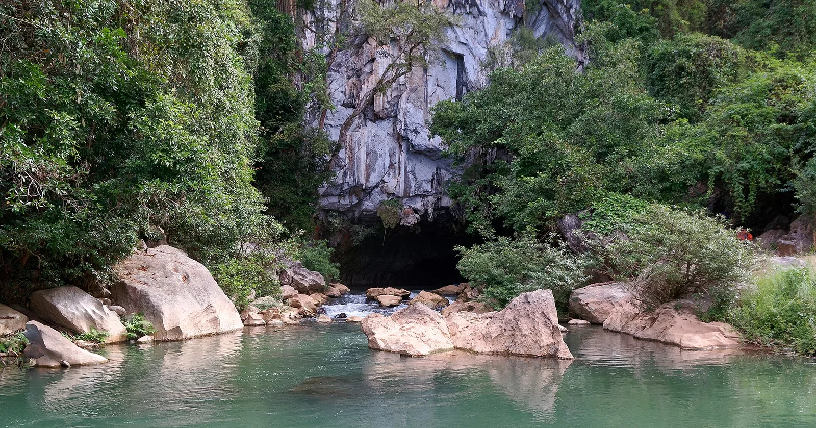 The limestone cave mouth and turquoise pool at Kong Lor Cave on the Thakhek Loop
