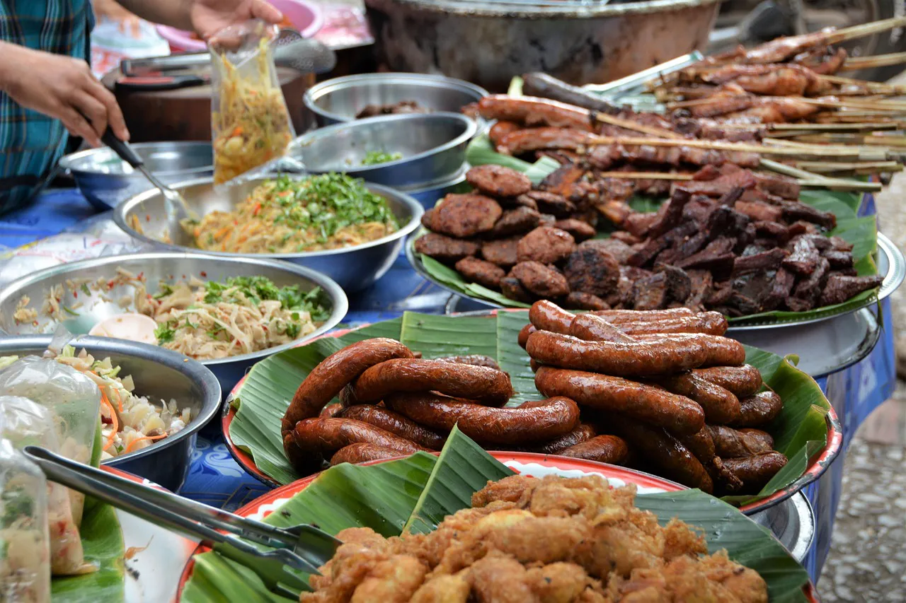 Grilled meats, sausages and salads at a Luang Prabang food market