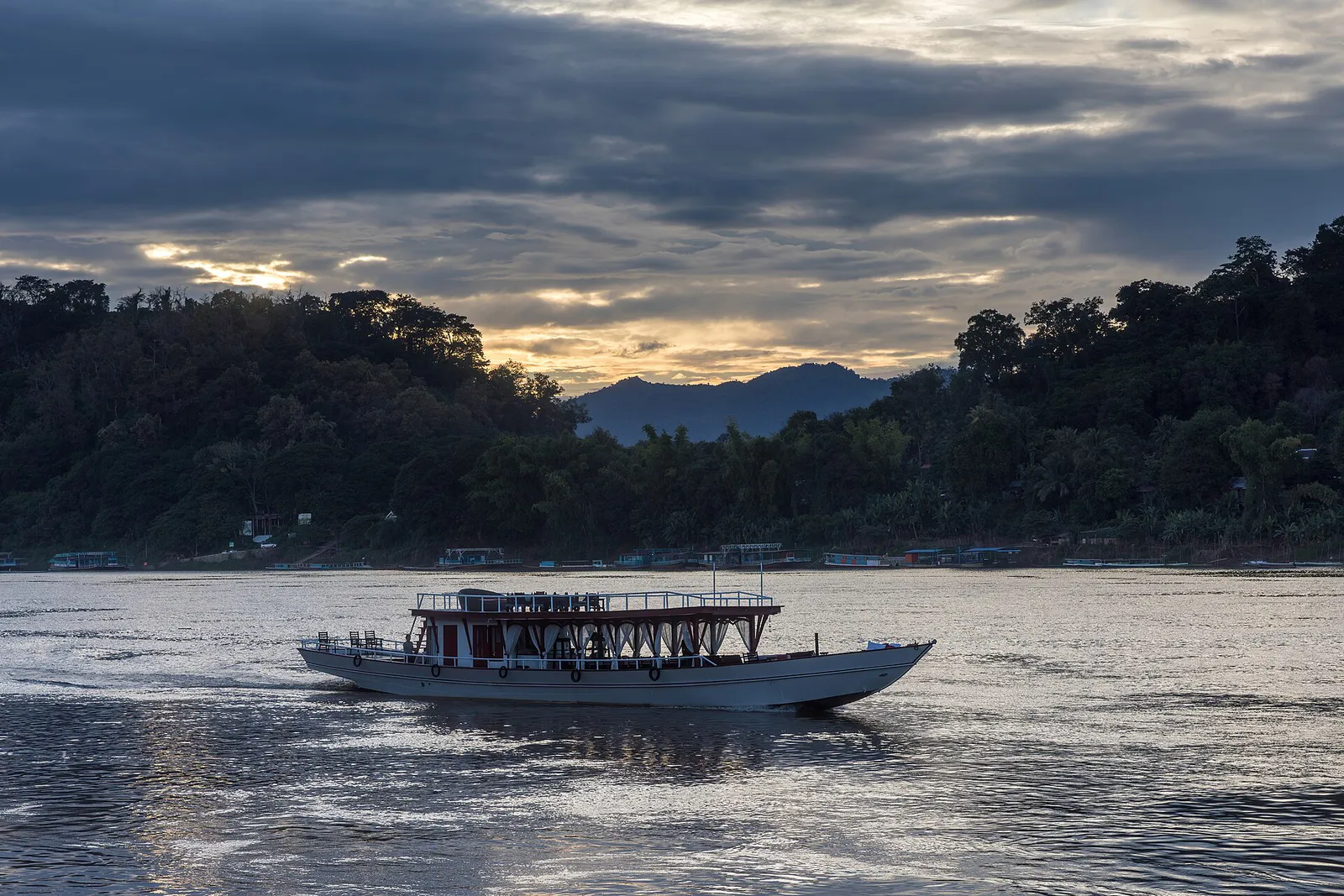 Slow boat crossing the Mekong at sunset near Luang Prabang