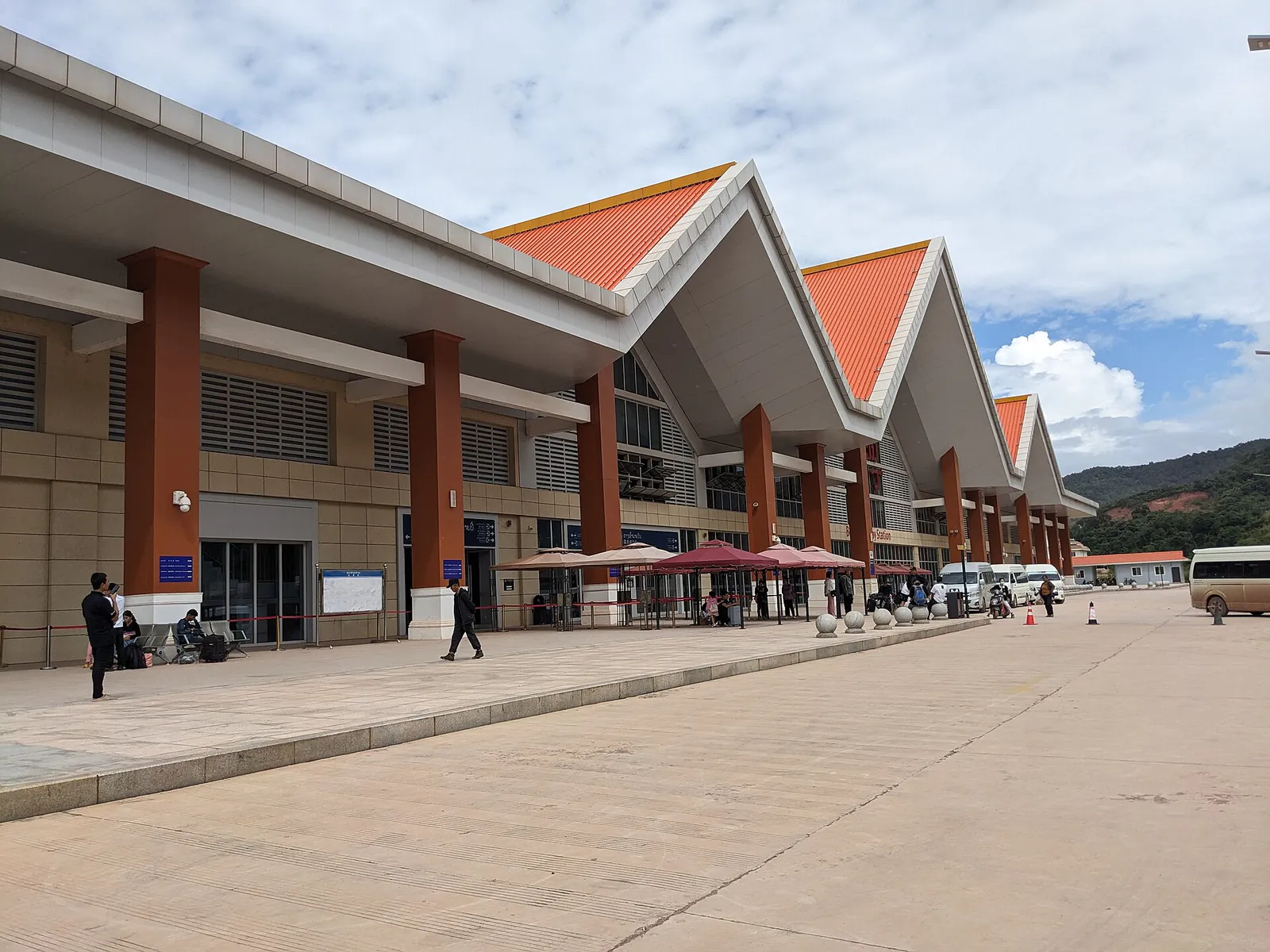 Modern Laos–China Railway station with orange tiled roofs