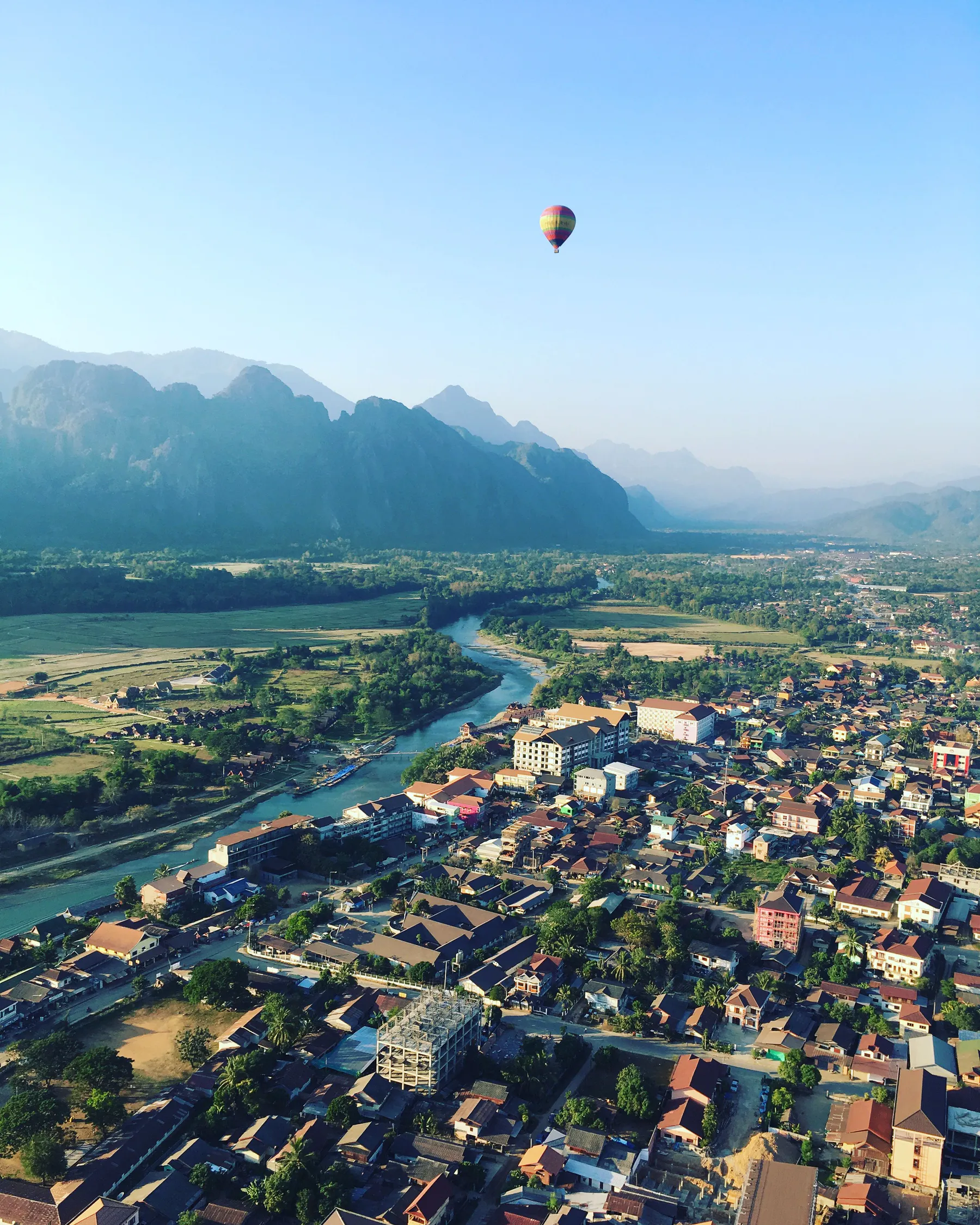Hot-air balloon above the limestone mountains and river at Vang Vieng