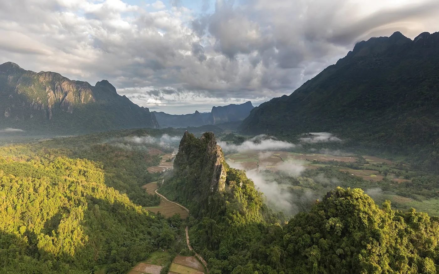 Karst mountains over rice fields near Vang Vieng at golden hour